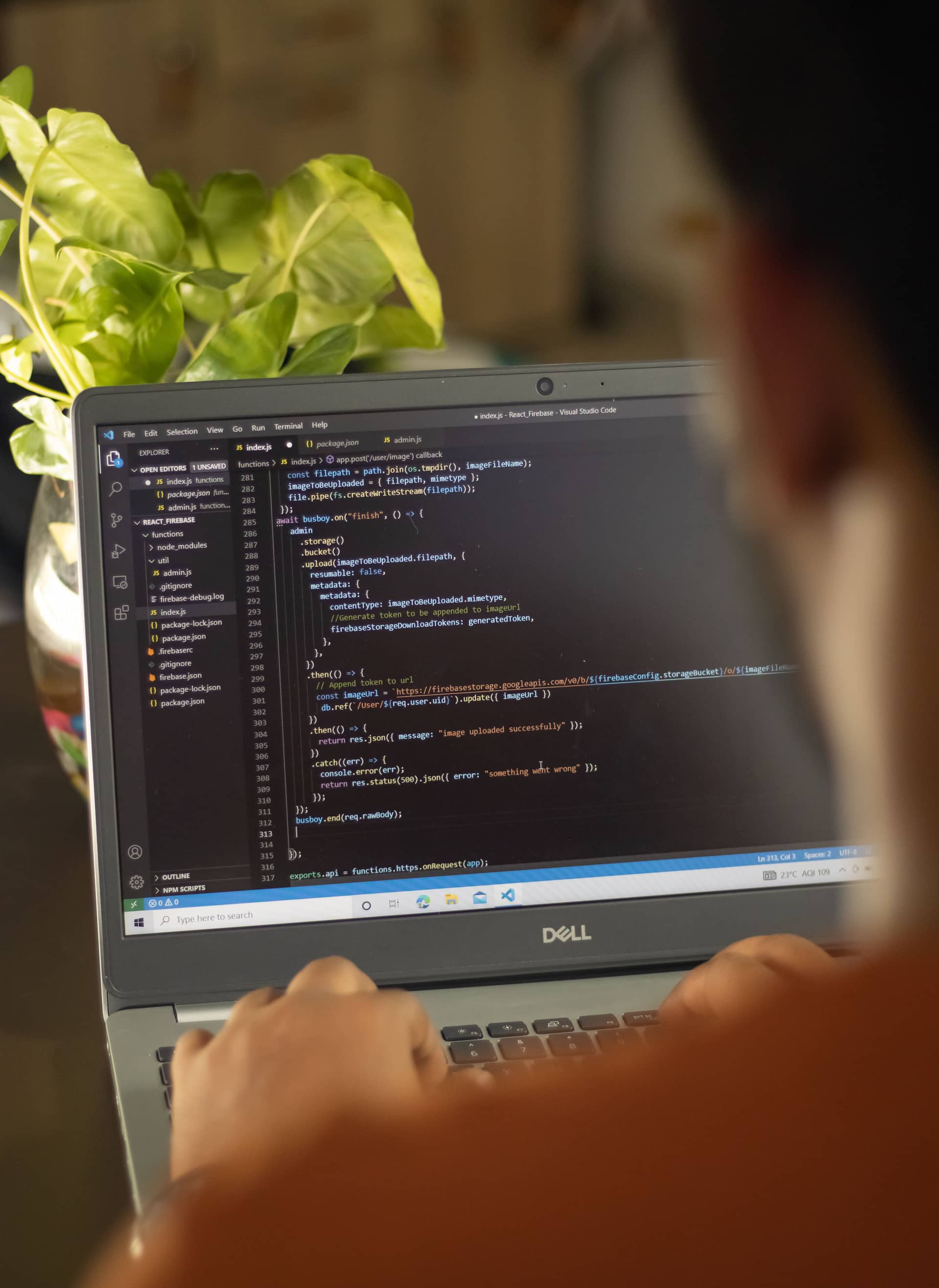 A developer writing Firebase and Node.js functions in VS Code