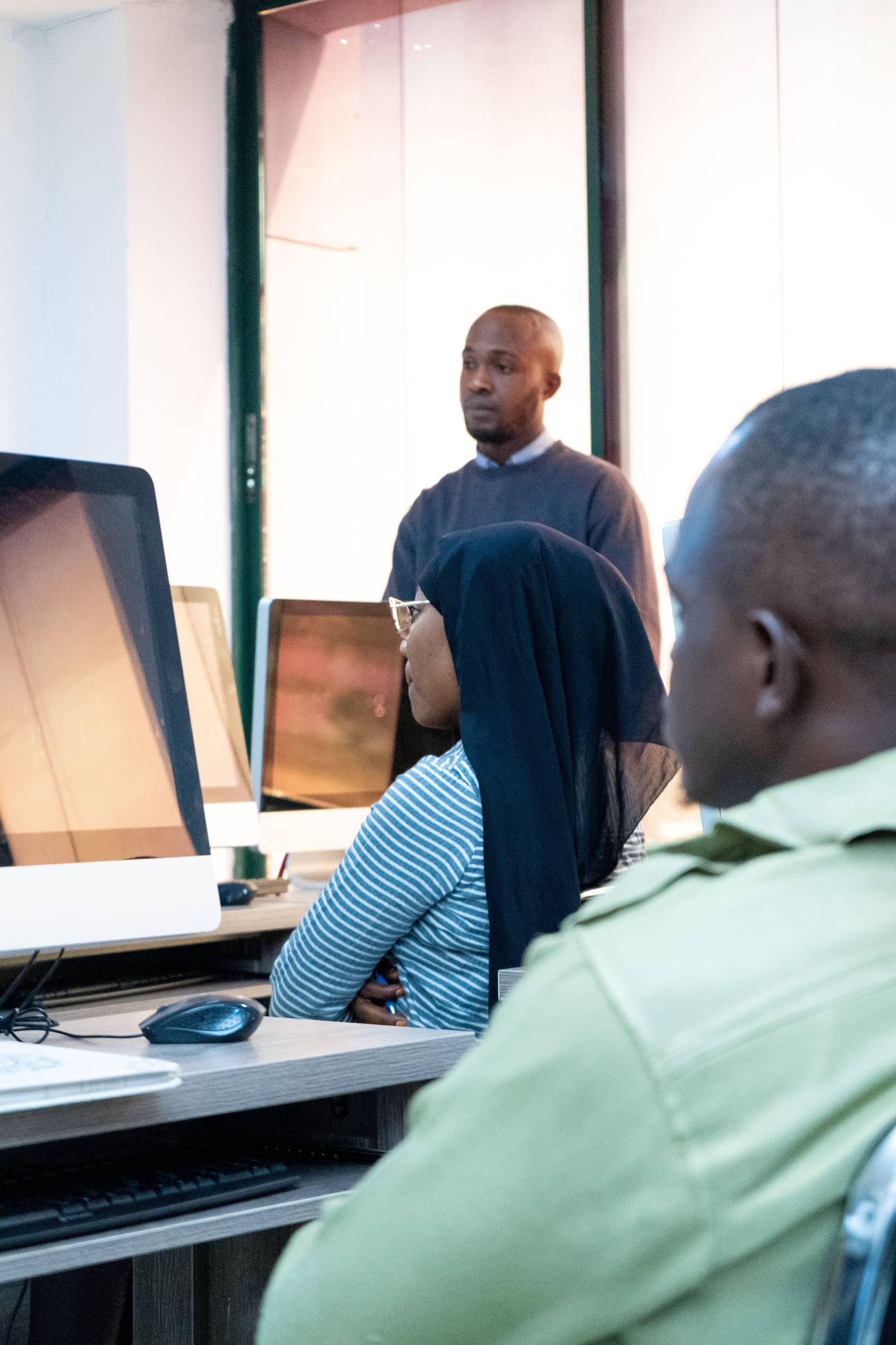Learners in a modern computer lab following a session