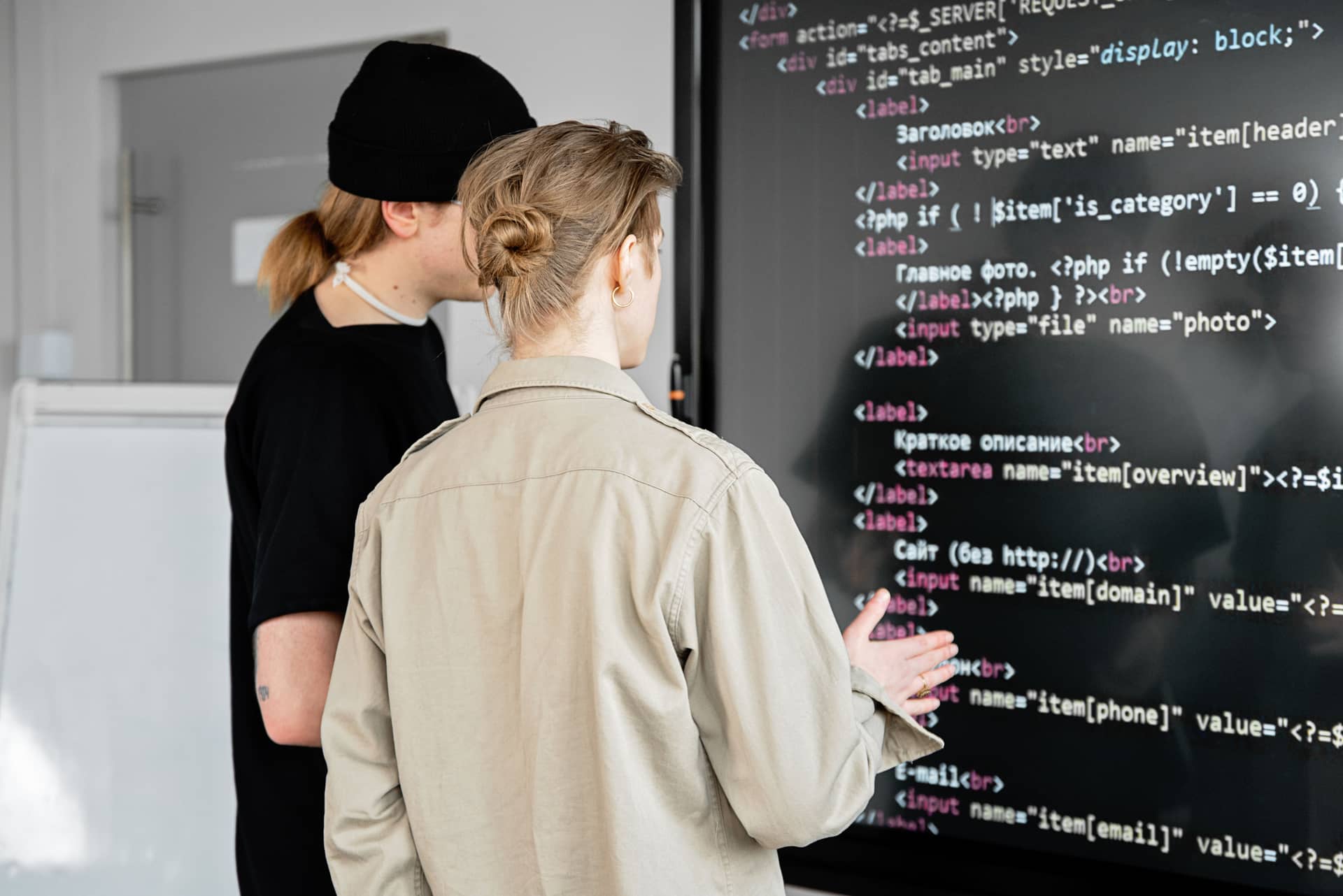 Two developers reviewing a full-screen codebase together